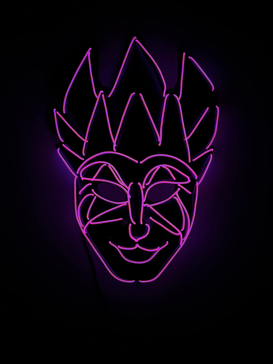 Purple neon sign depicts a smiling mask with a spiked crown on a black background.
